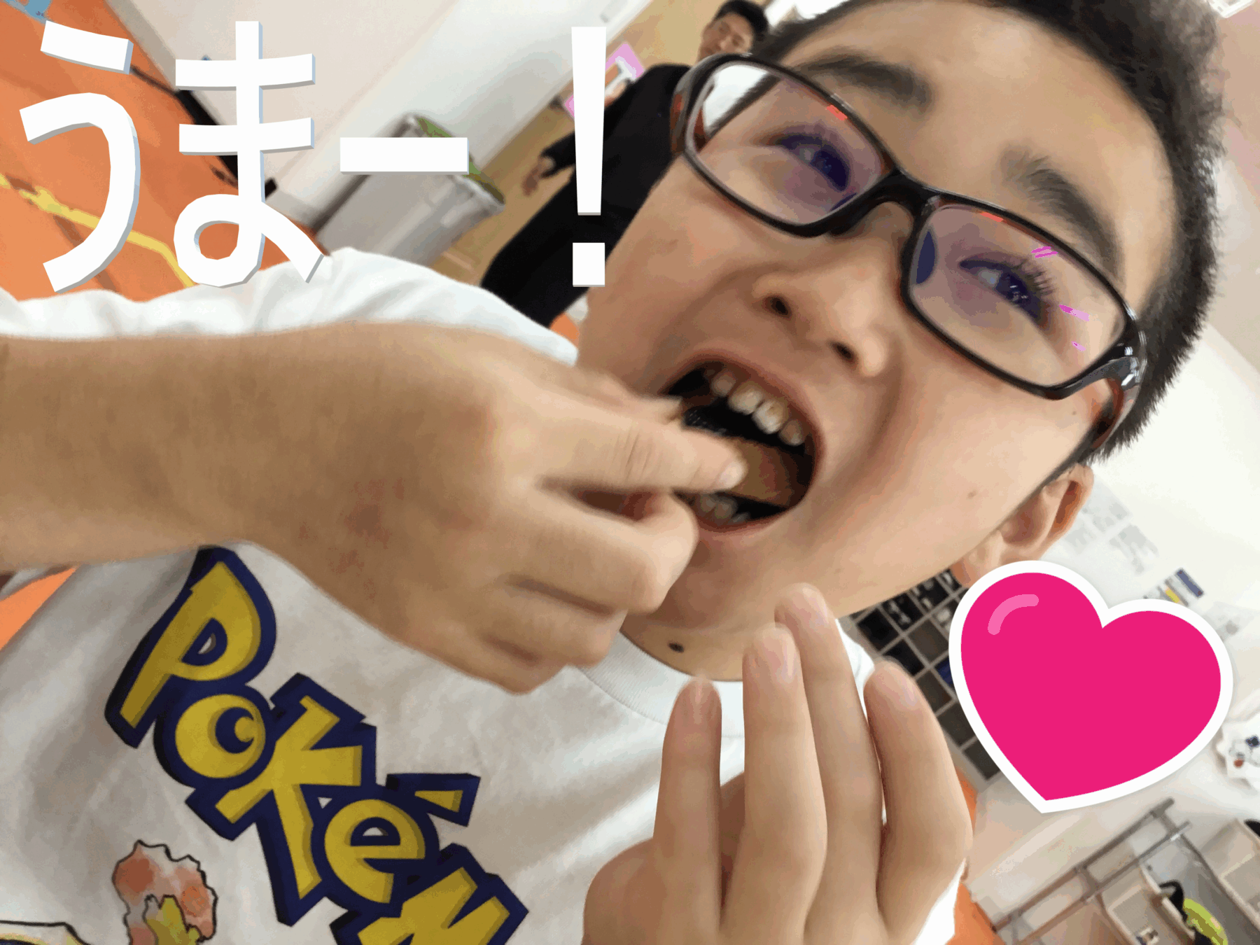 Selfie of a young person wearing glasses, playfully biting a finger, with a bright pink heart sticker and large white text overlay in the background.
