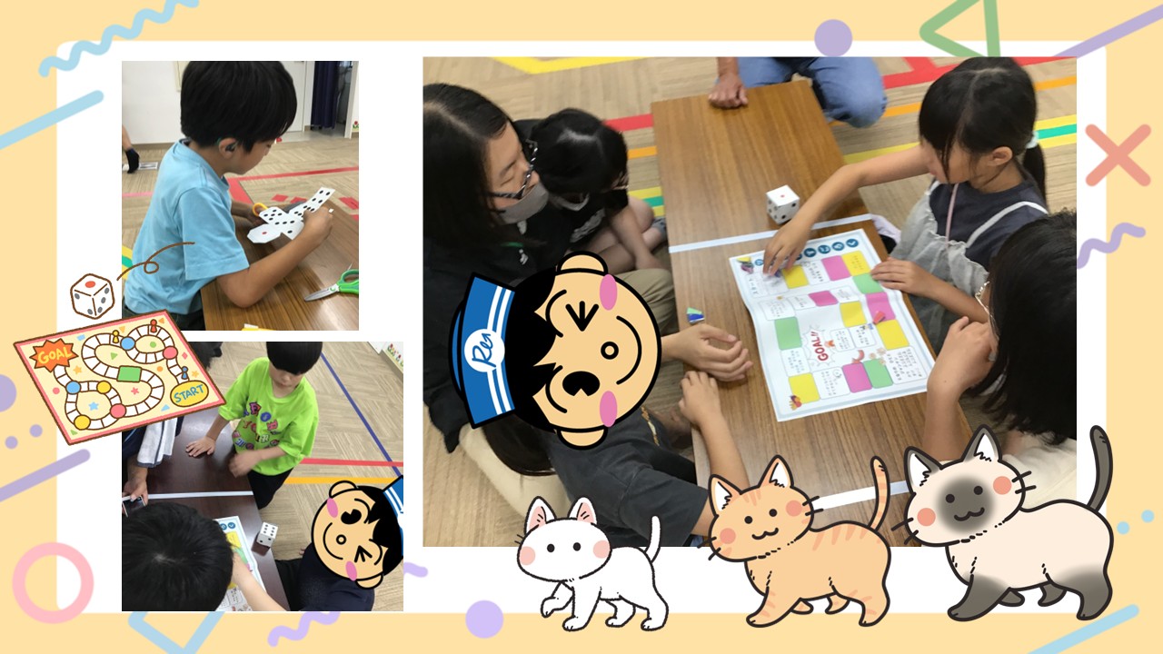 Group of kids around a table playing a colorful board game with dice and a instruction sheet in a classroom setting.