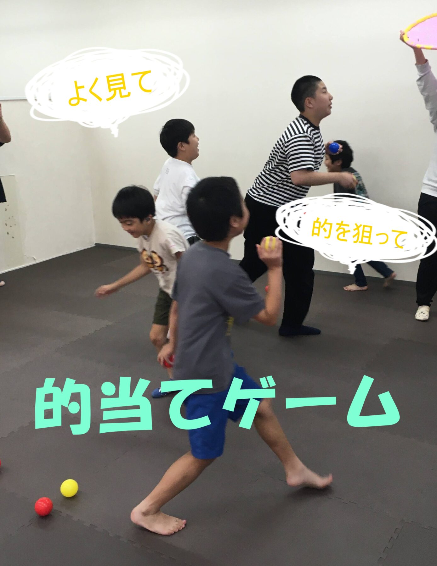 Children playing a fast-paced ball game in a padded gym, chasing small colored balls on the floor as others run around.